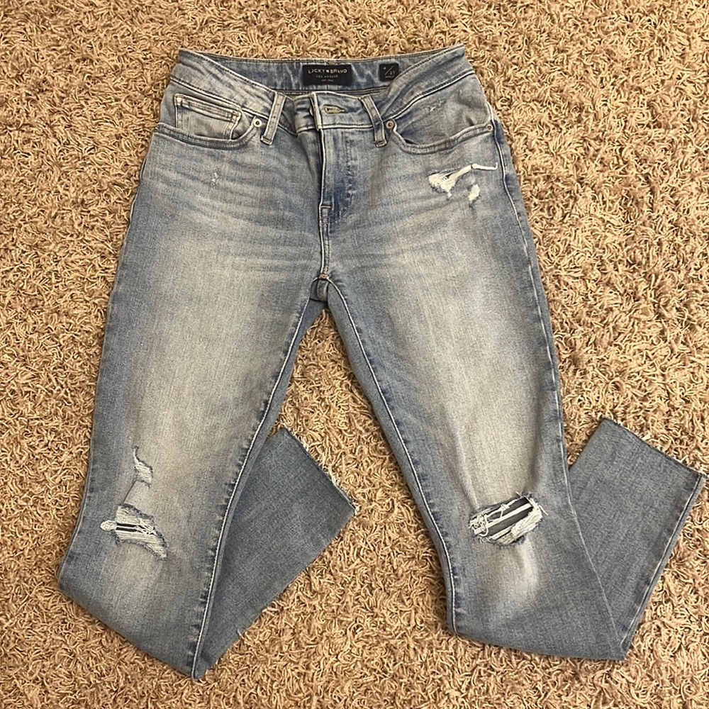 light wash, holes on the knee, frayed ankles